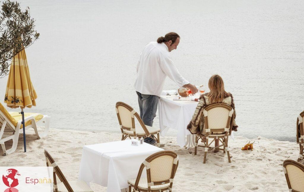 man and woman having meal at the shore