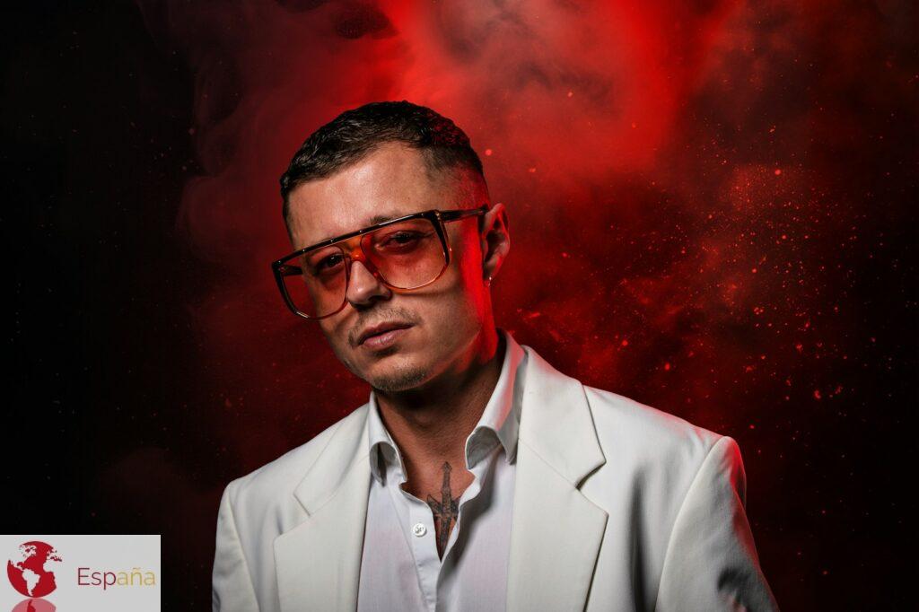 A man in a white suit and red glasses