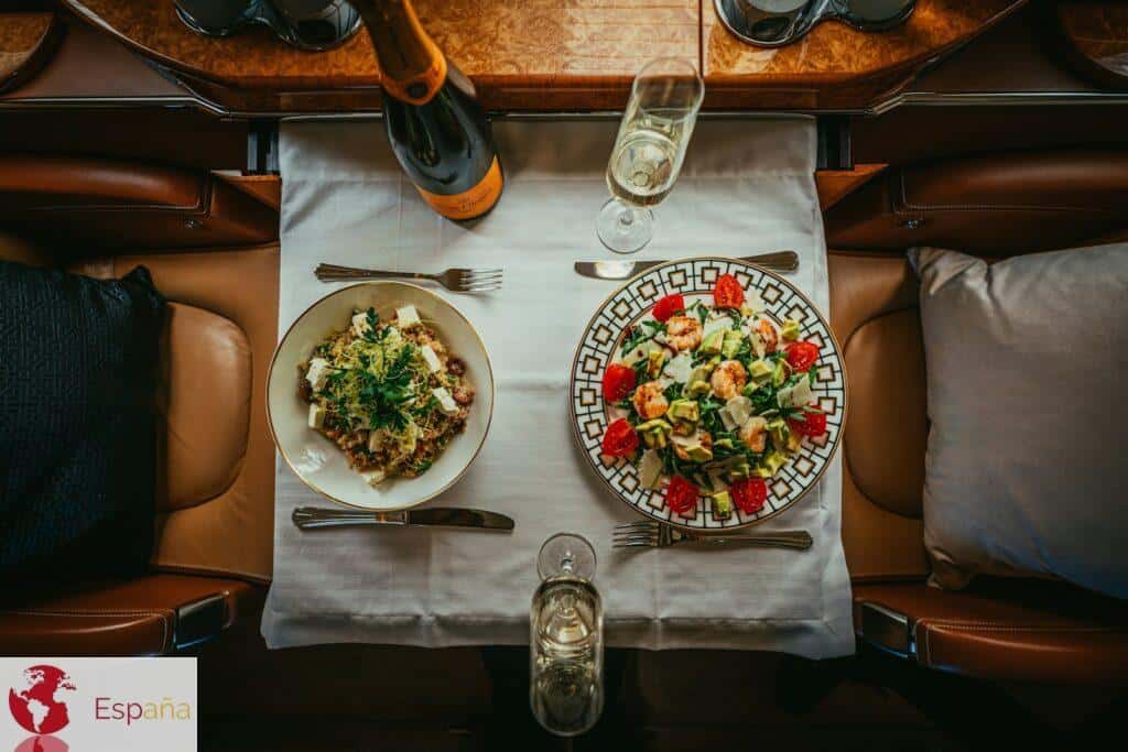 a table with plates of food and glasses on it