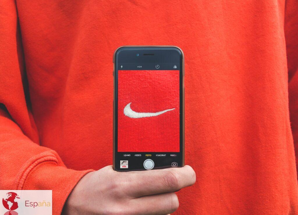 person holding iPhone taking picture on Nike label