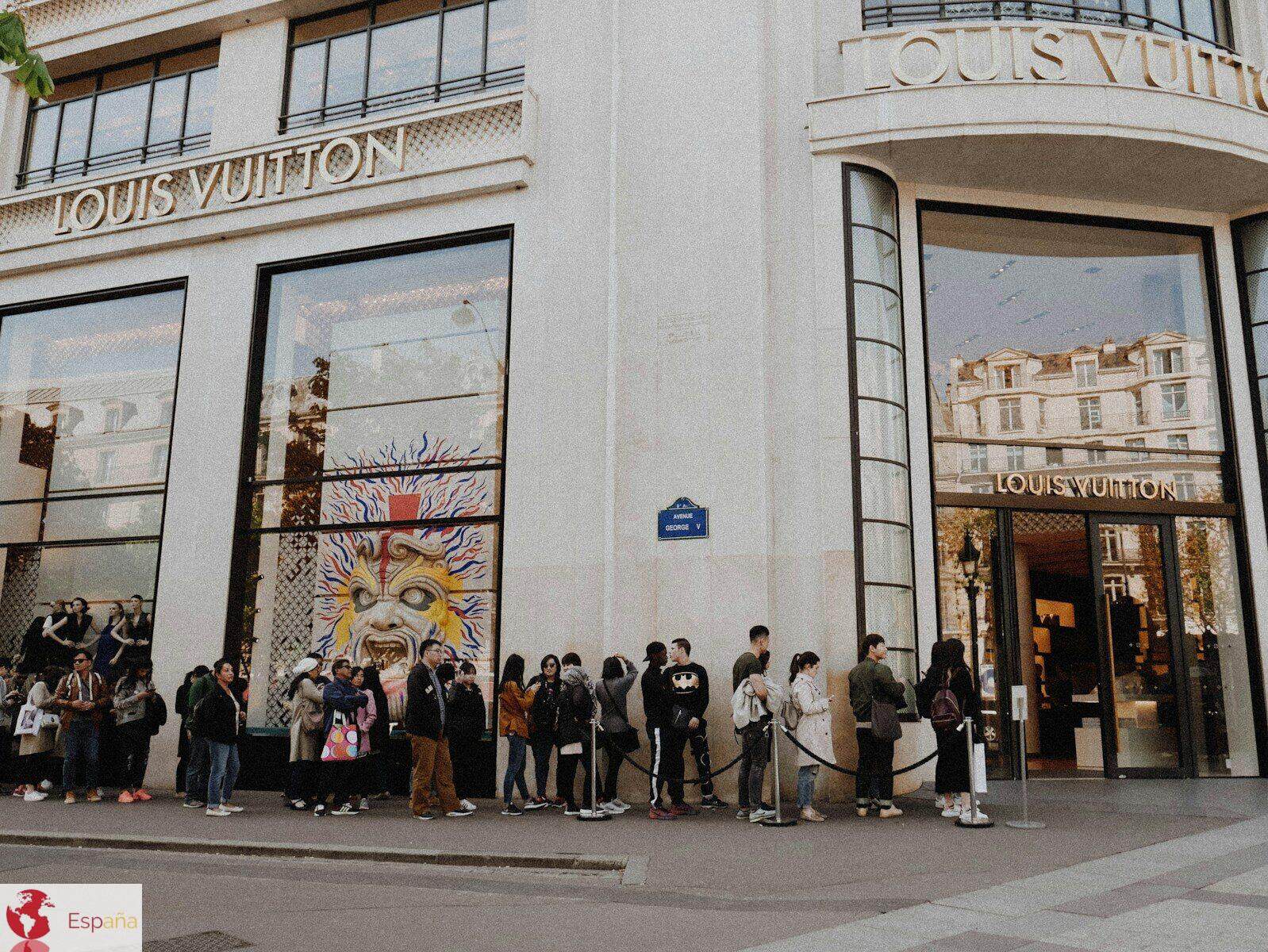 people queuing beside Louis Vuitton store