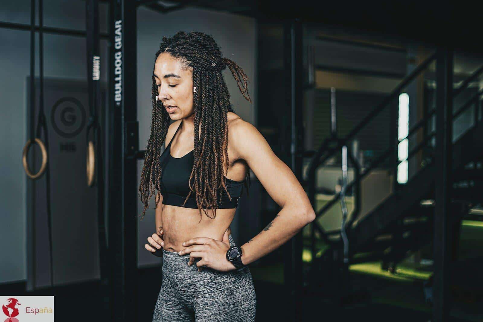 a woman with dreadlocks standing in a gym